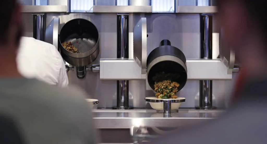 Robotic Woks Serve Food To Customers At